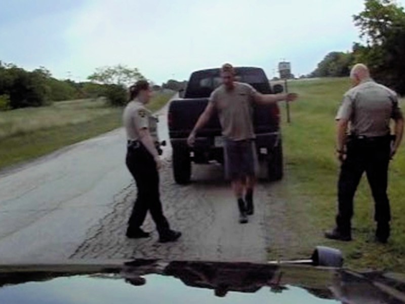 Screenshot of Thomas, a former Texas firefighter who was arrested under false DUI charges, doing a field sobriety test in front of two Denton County sheriffs in April, 2021. Screenshot pulled from dash camera footage and provided courtesy of the Denton County, Texas, Sheriff's Department.